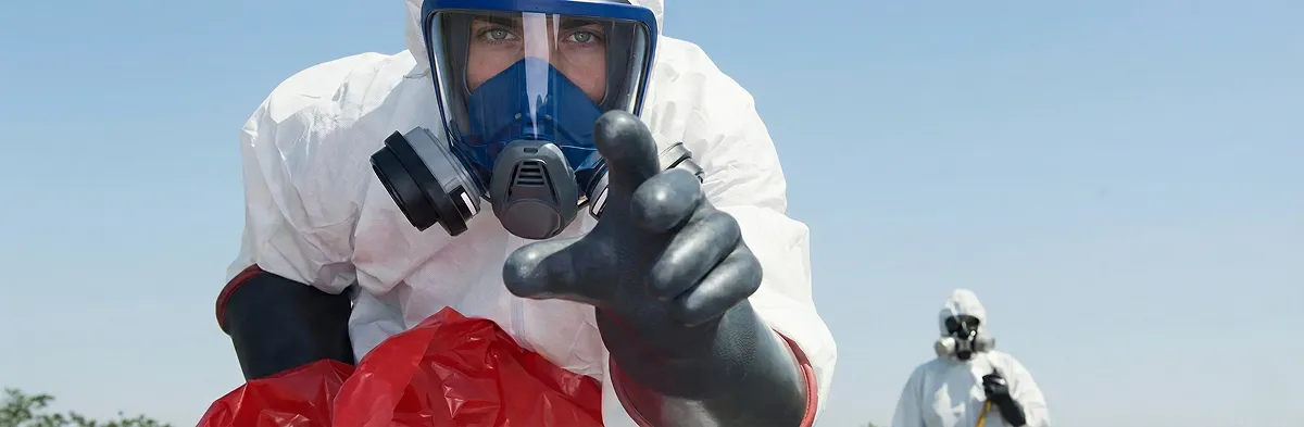 sewage clean up technician wearing protective gear handling biohazard materials in Worcester, MA