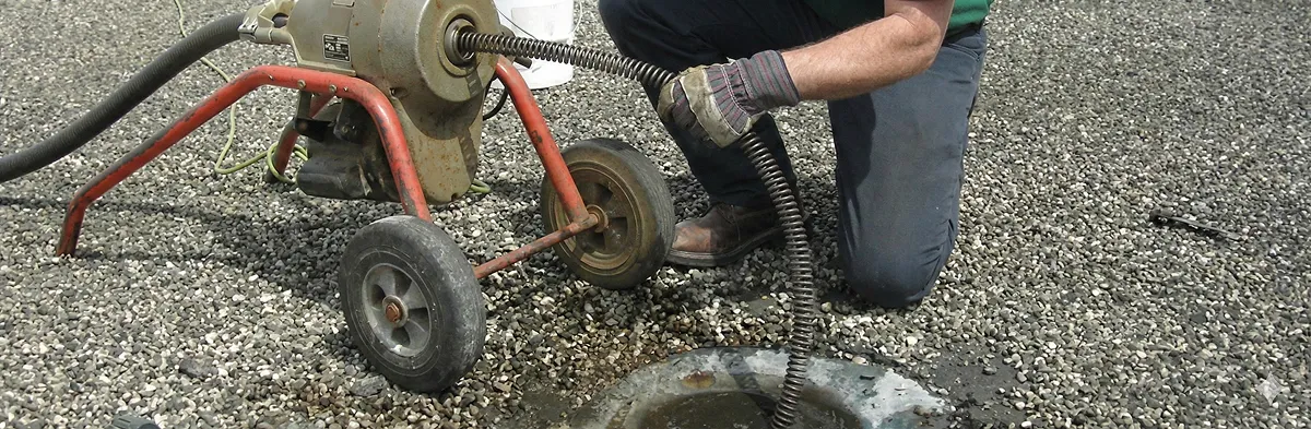 sewer rodding technician actively removing blockages from a sewer line in Worcester, MA
